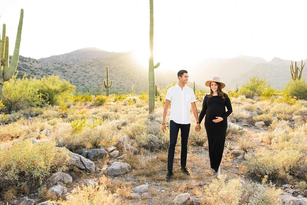 mom and dad to be holding bump for pregnancy photo