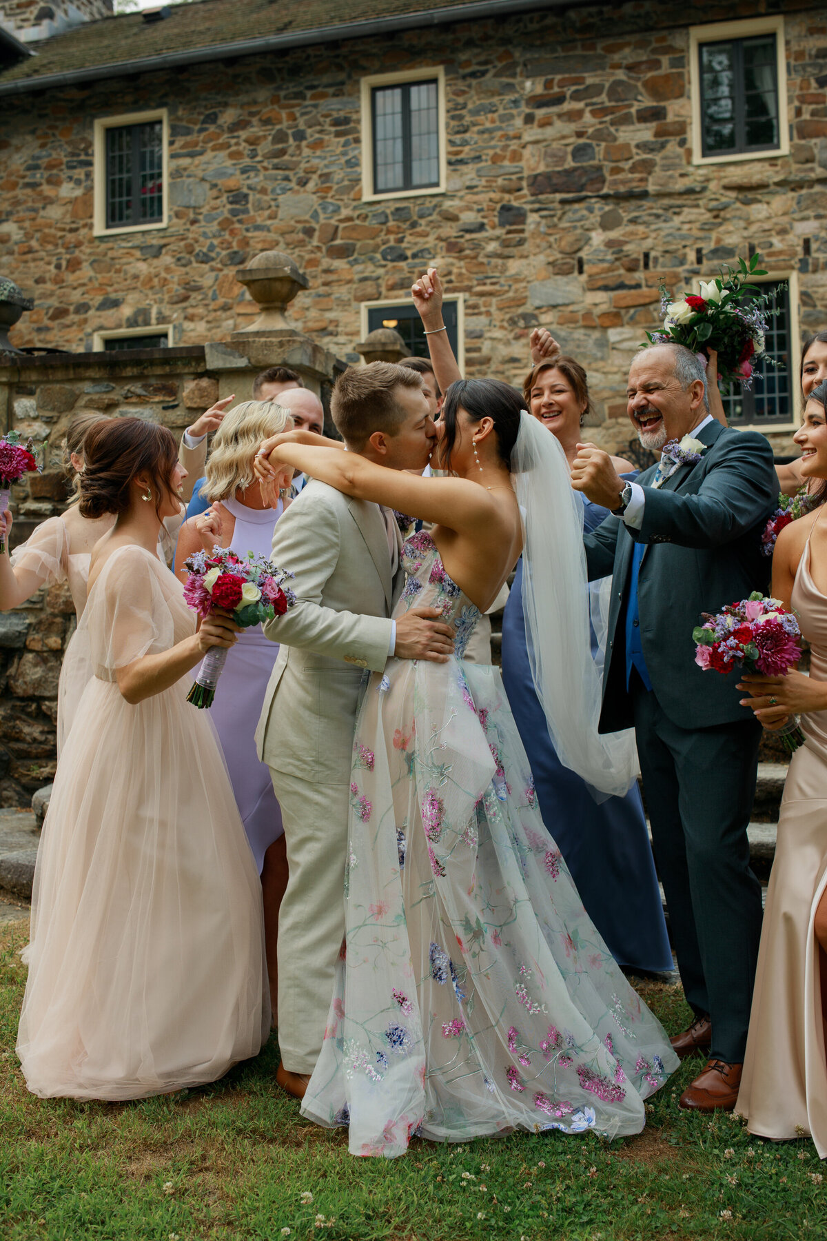 bride and groom surrounded by family and friends at their wedding