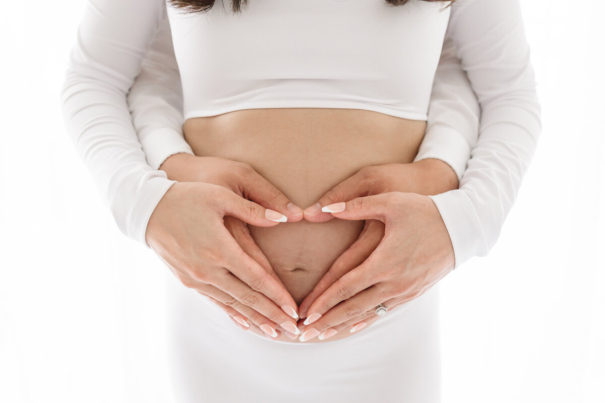 heart with hands on belly