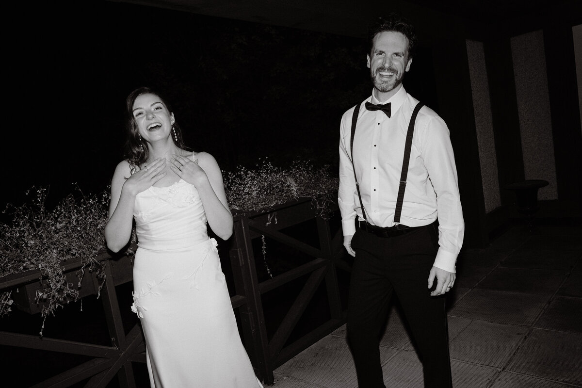 happy couple laughing candidly late at night at their wedding