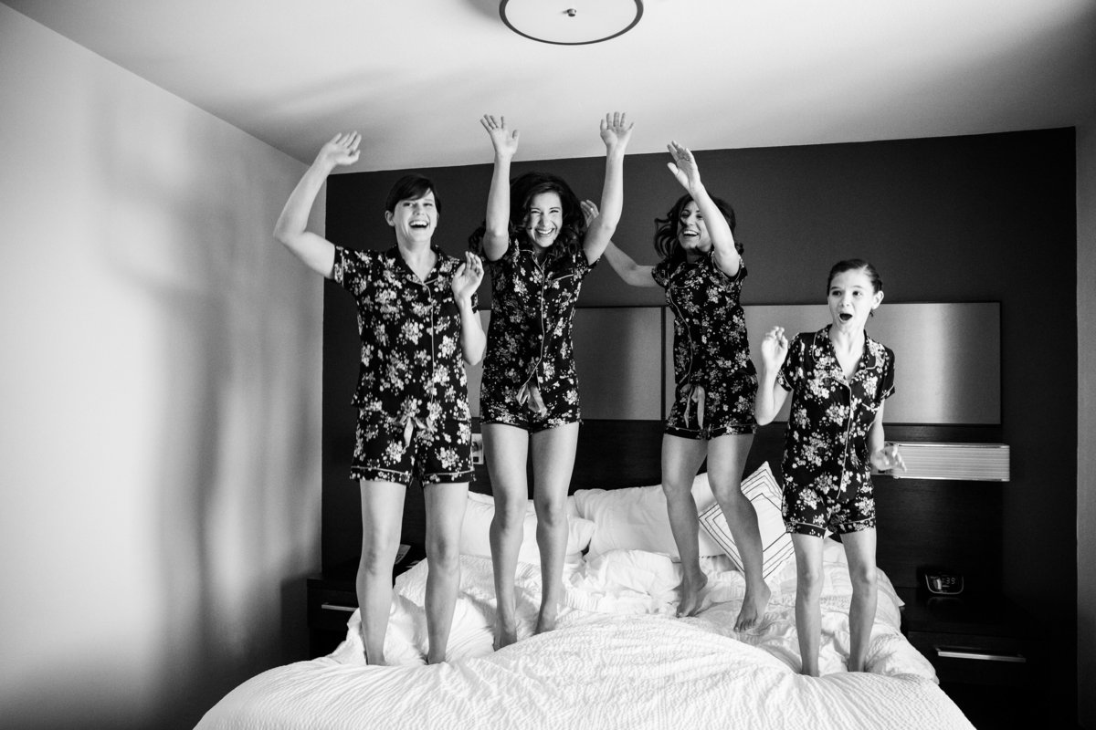 canyonwood ridge wedding photographer girls jump on bed at hotel 250 S Canyonwood Dr, Dripping Springs, TX 78620