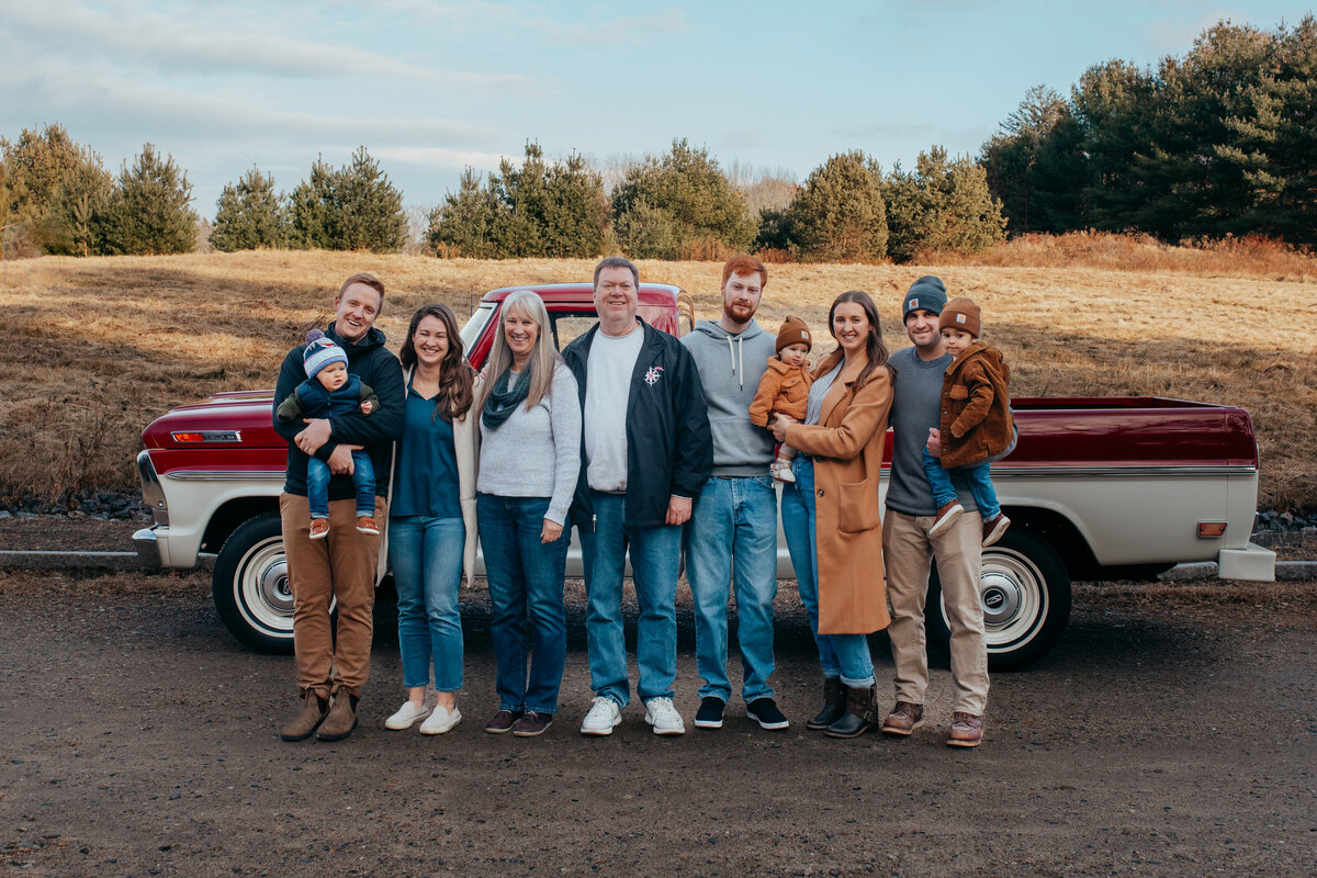 family photo in front of vintage truck