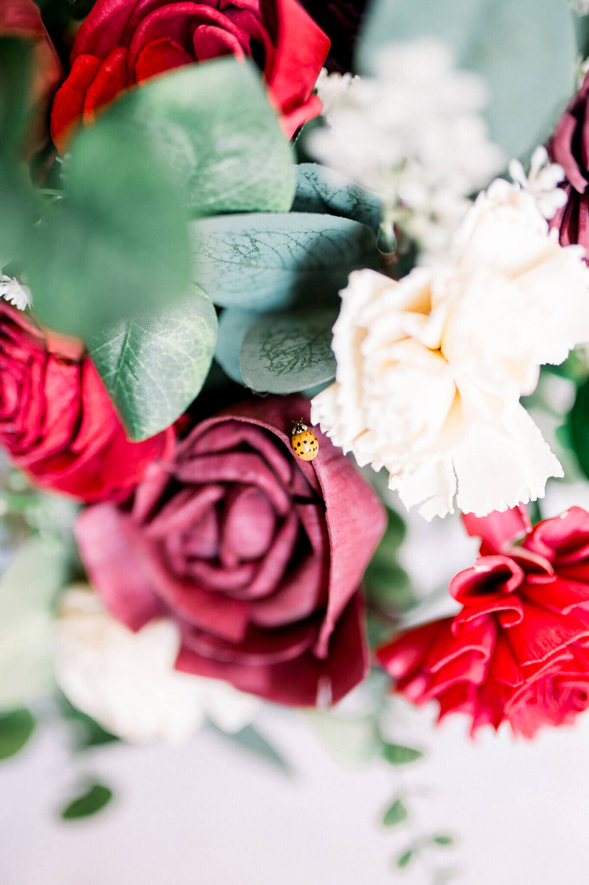 Niagara Wedding Photographer captures an image of a lady bug in brides wedding bouquet