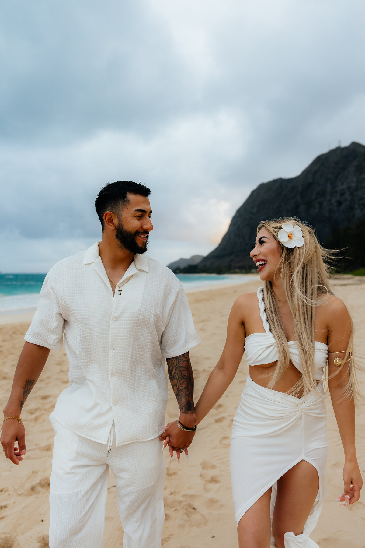 Couple taking a walk on Waimanalo Beach at Sunset captured by true to color photographer Lexi Rae photo