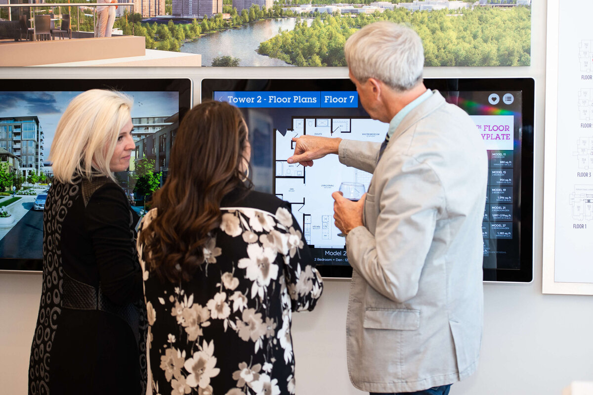 Ottawa event photography showing guests of the eQ groundbreaking event looking at model home plans.  Captured by JEMMAN Photography COMMERCIAL