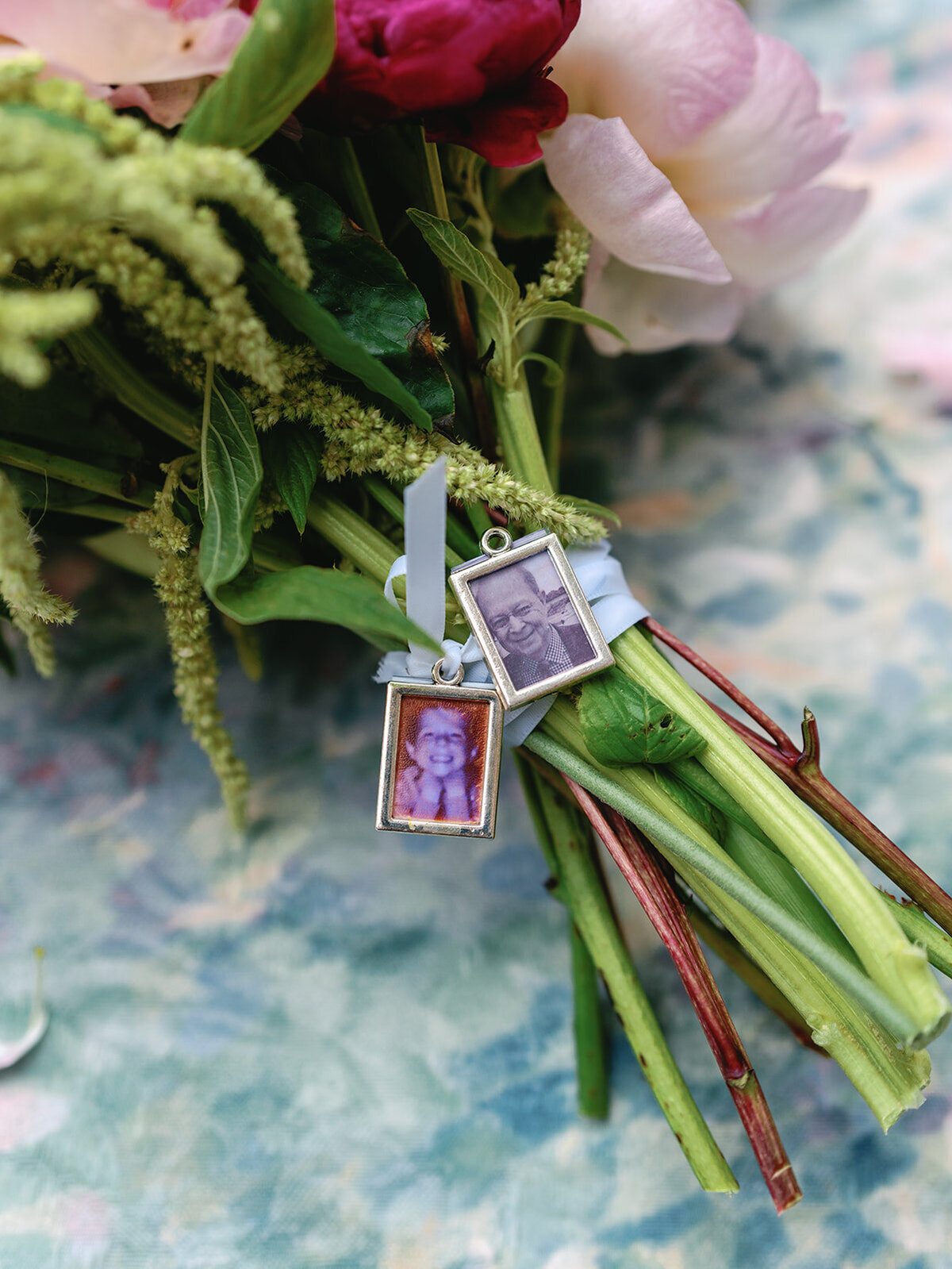 Family pictures on a charm from a bridal bouquet