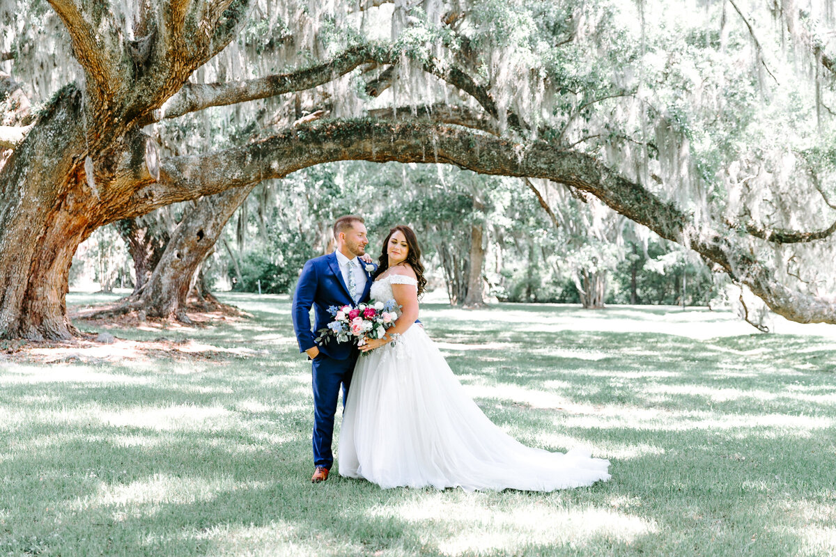bride and groom under oaks at Magnolia Plantation