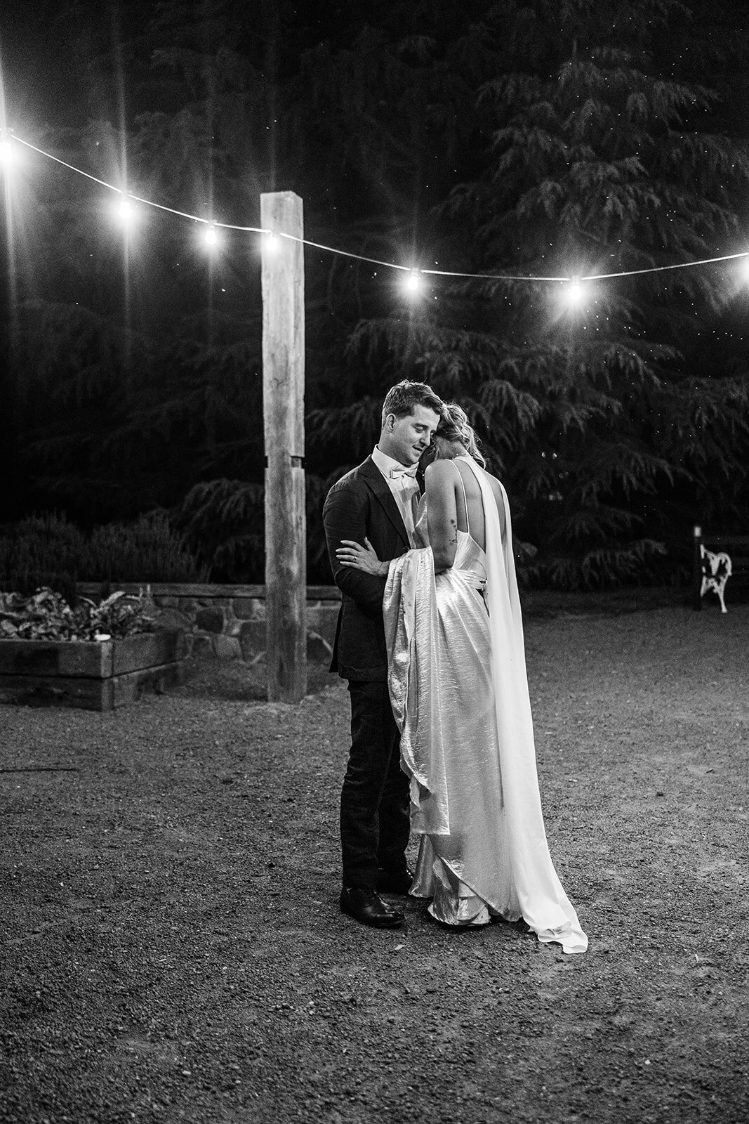 Bride and groom dancing under the festoon lights at Poachers Pantry during their wedding reception