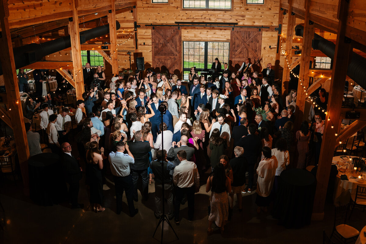 Elegant reception setup with candles, florals, and wooden tables