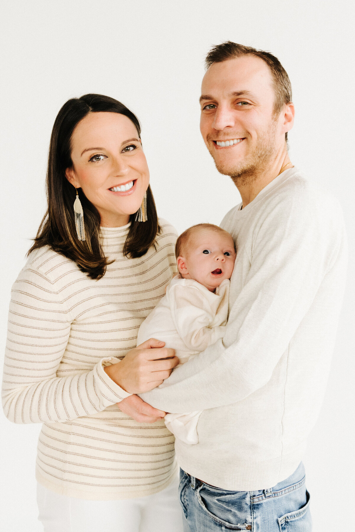 parents smiling with baby girl