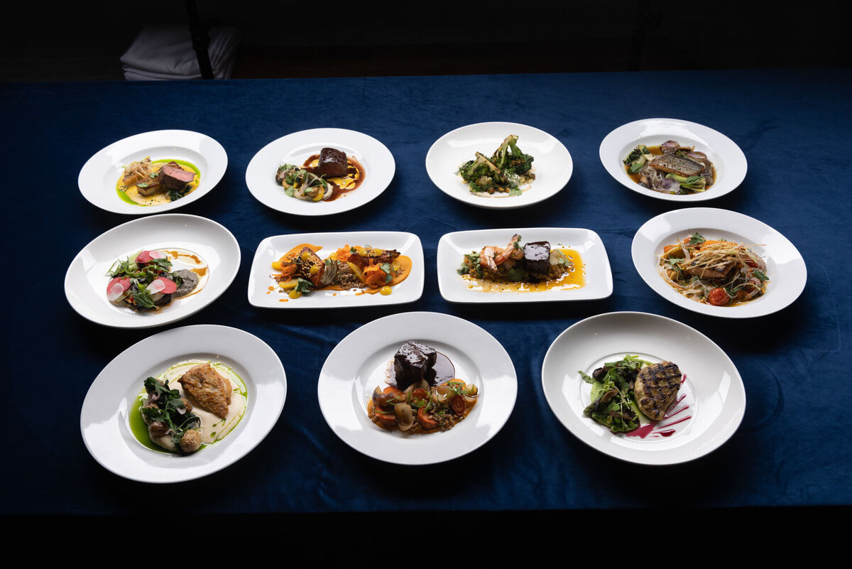 Assorted plated meals on a blue tablecloth