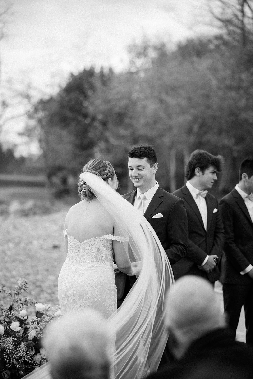 Bride and groom exchange vows during intimate outdoor ceremony surrounded by the Atlantic ocean in Boston, MA.