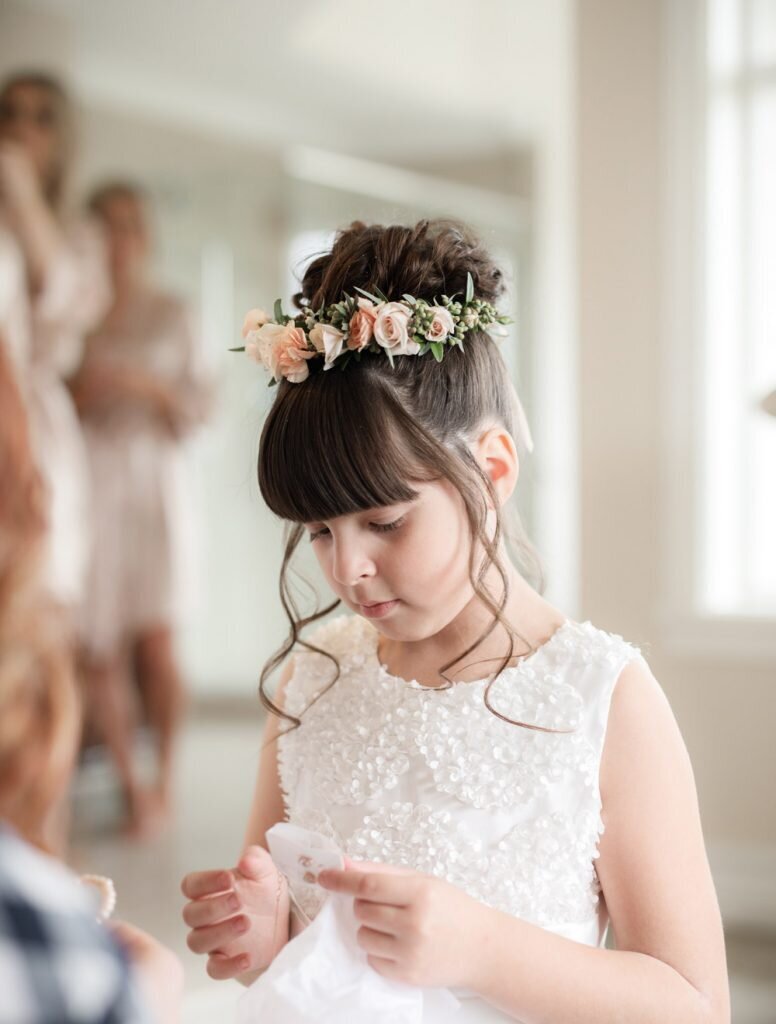 Flower girl with updo arranged with flowers