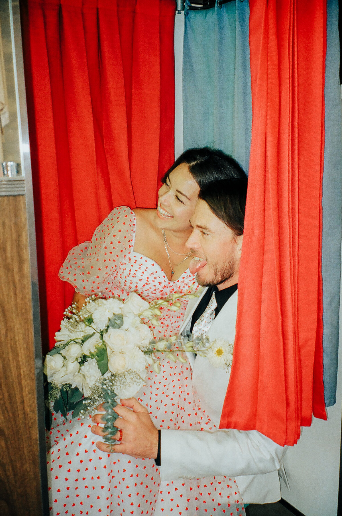 couple in photo booth at chapel on  film