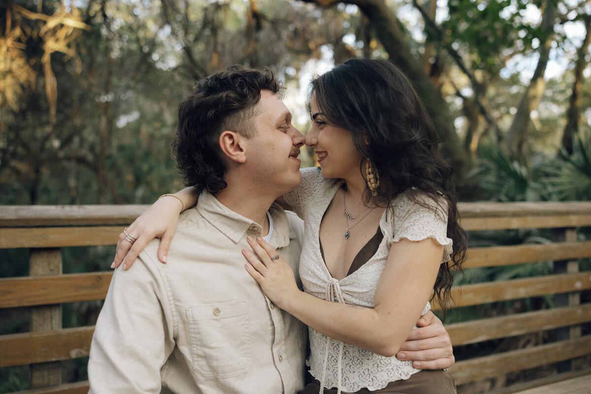 couple embraces on bench in south florida