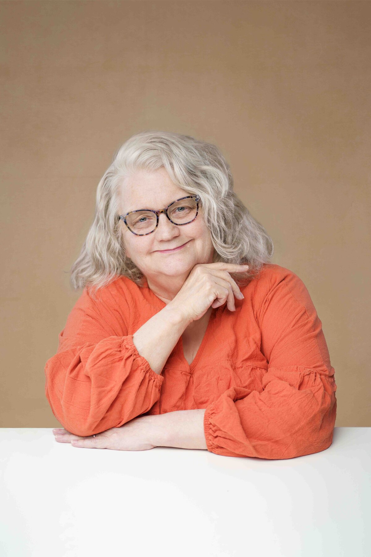 Puyallup Photographer Mature Female CEO Headshot Orange Shirt Silver Hair Lana Stewart Studios