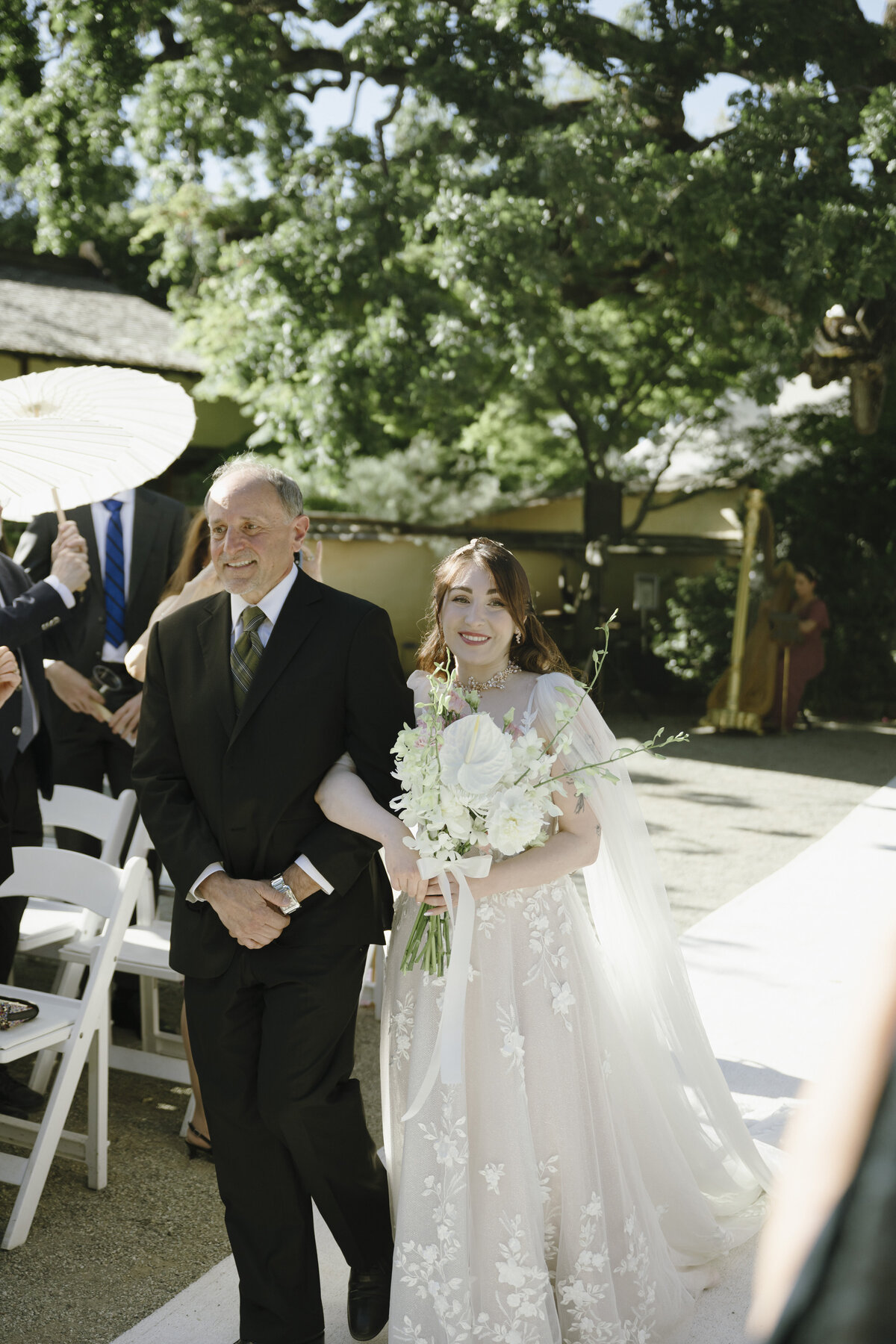 bride walking down the aisle with dad