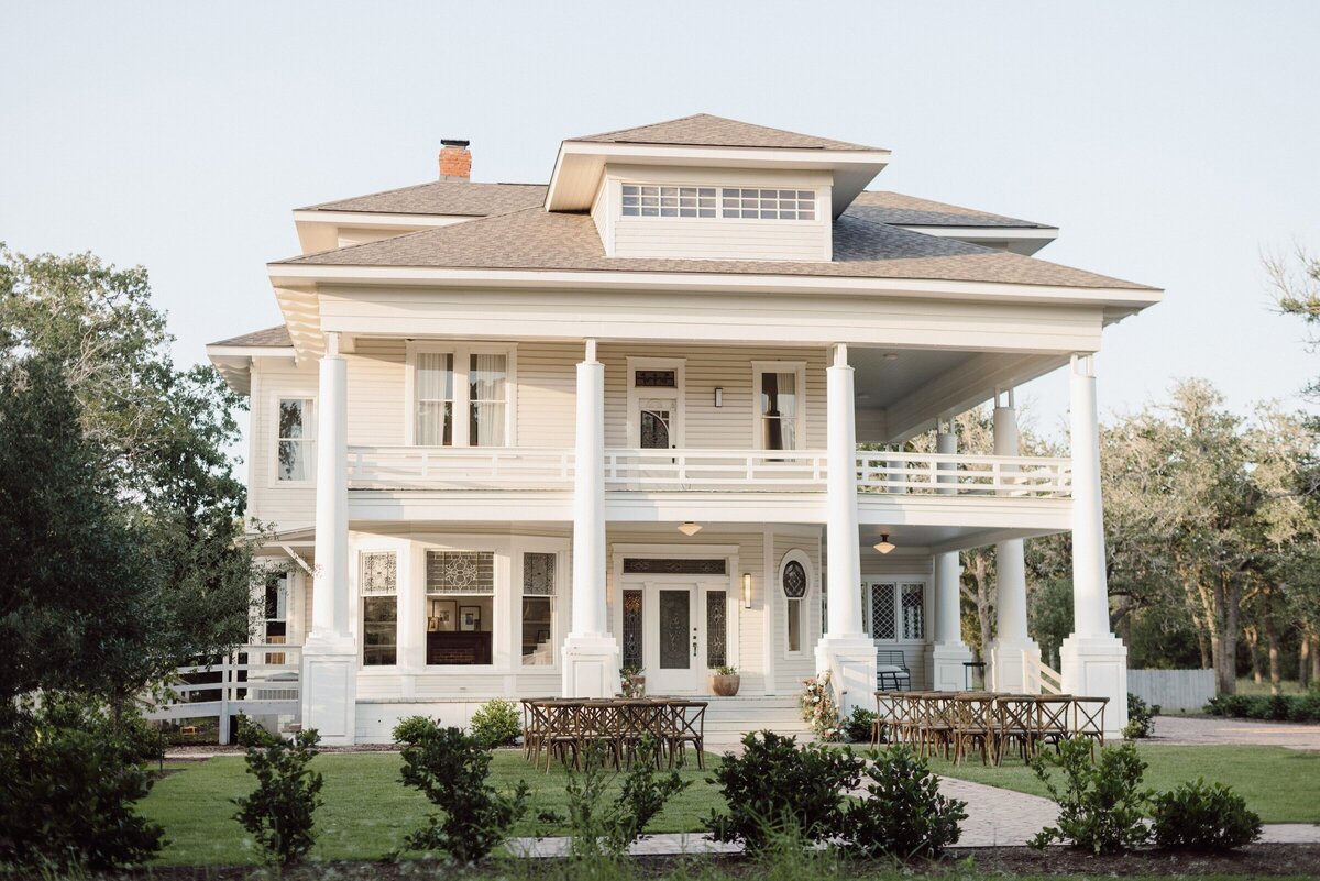 The Grand Lady's white 1881 mansion with wraparound porches