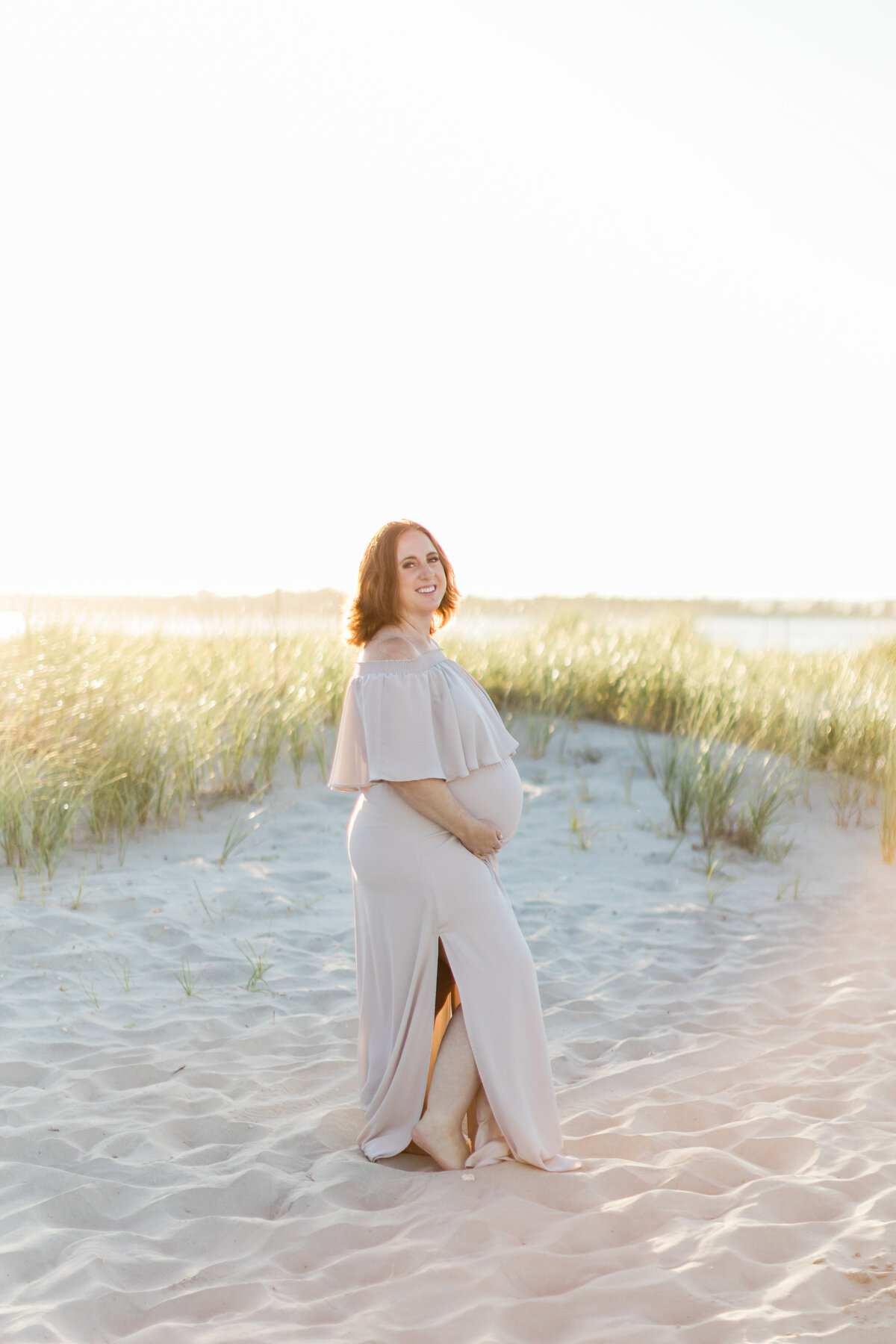 pregnant mom posing on the beach captured by South Jersey Maternity Photographer