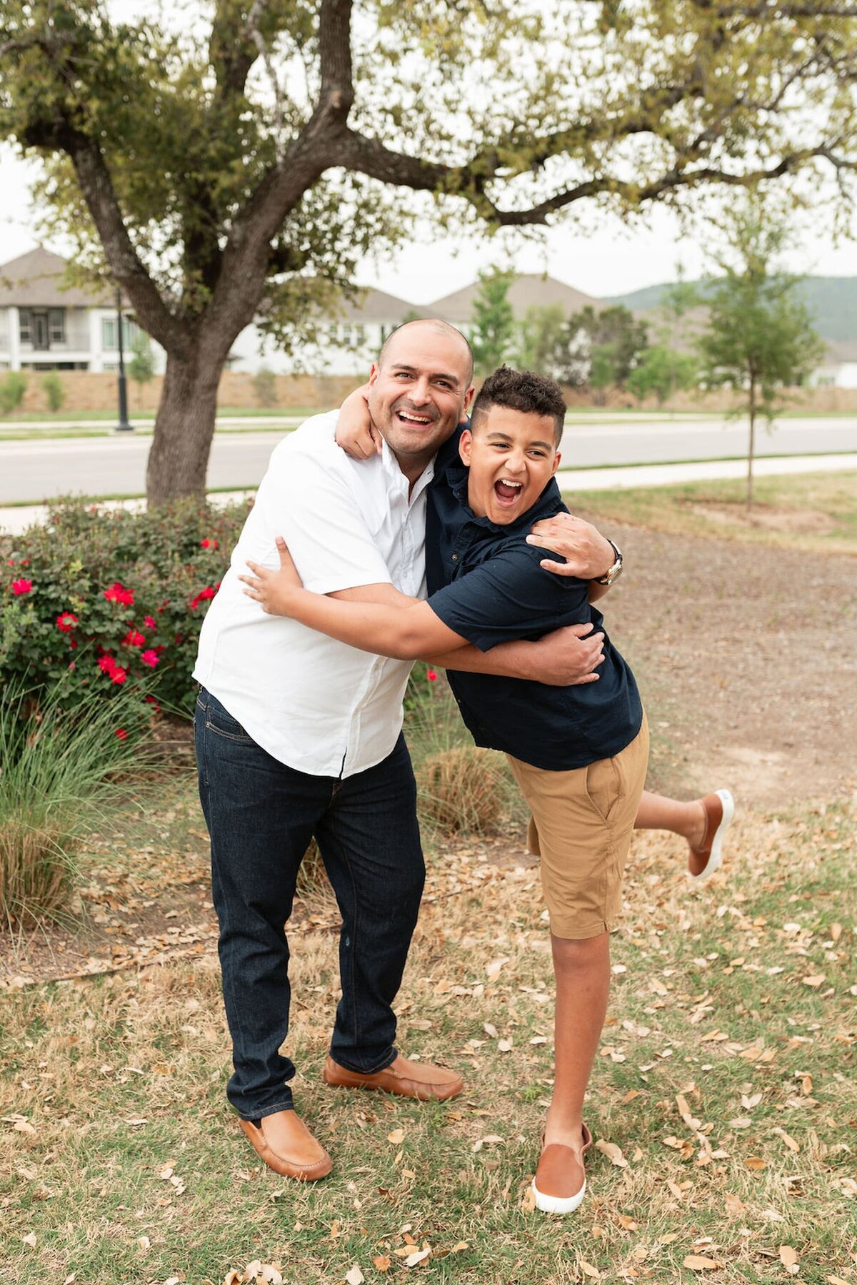 Miguel and Deacon walking side-by-side in an outdoor family portrait