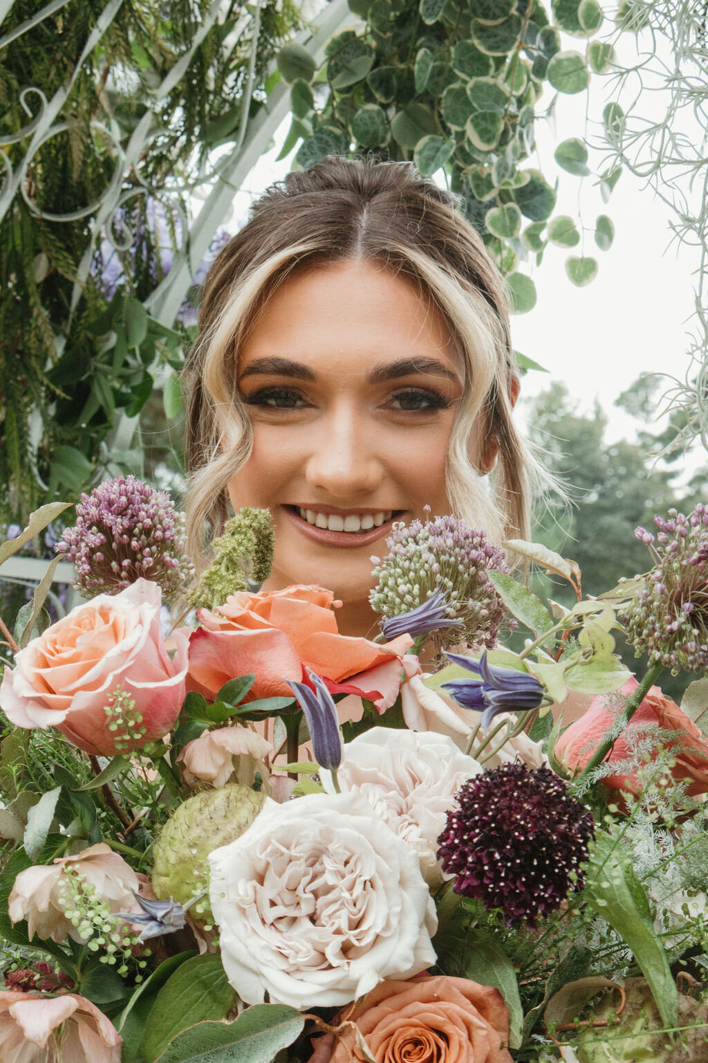 Bride holding her fresh flower bouquet at her wedding at The Rosewood venue Mount Vernon TX