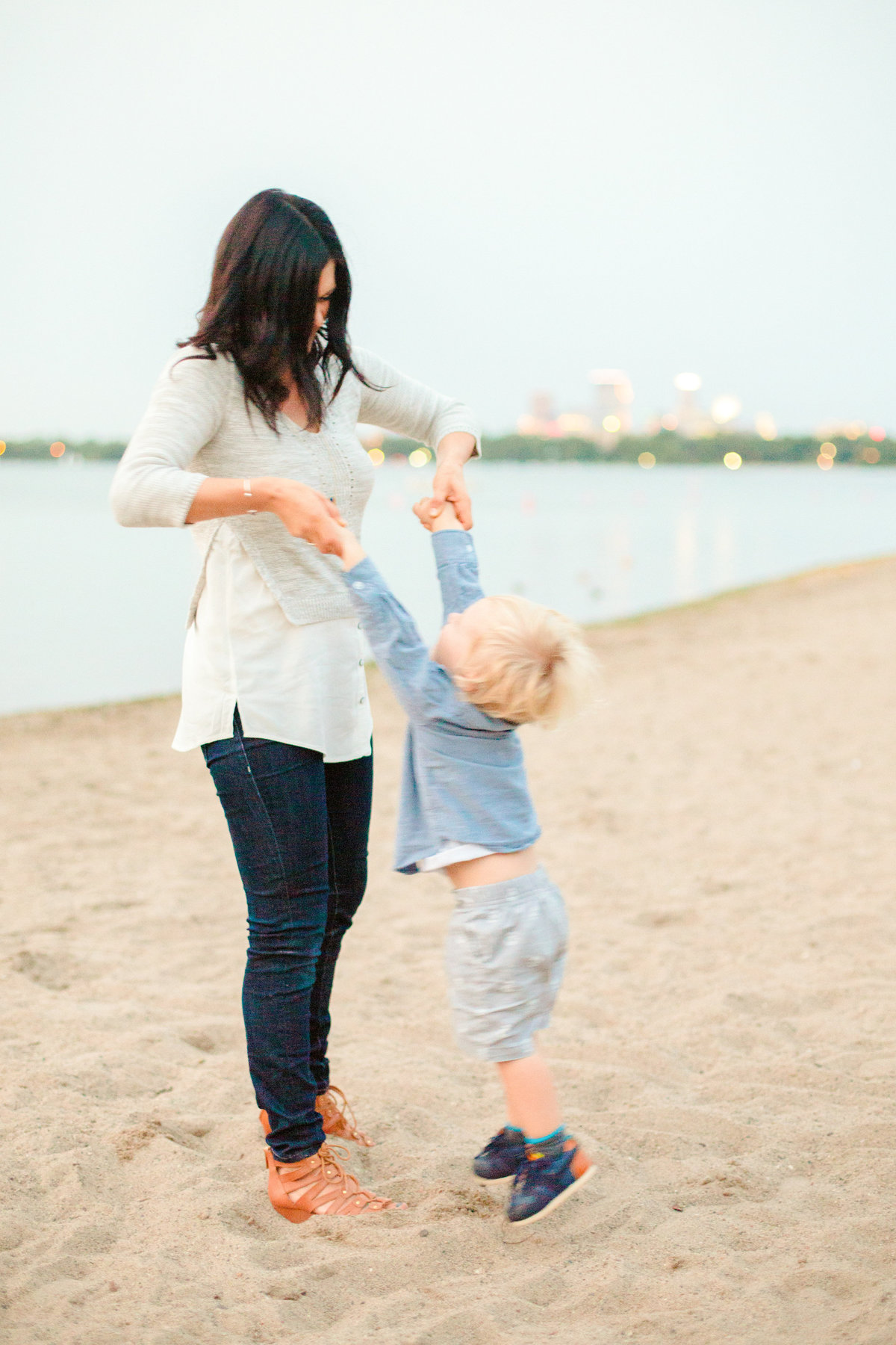 mom and son on sand beach of bde maka ska minneapolis minnesota