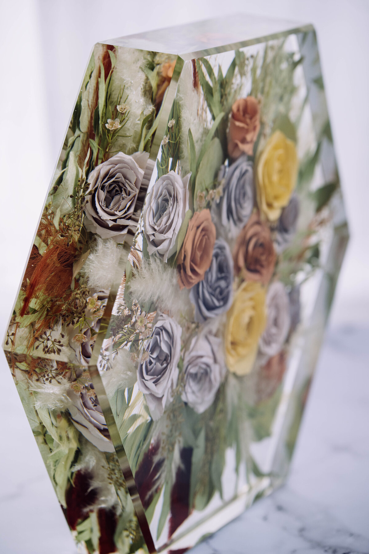 fresh looking flowers preserved in resin hexagon