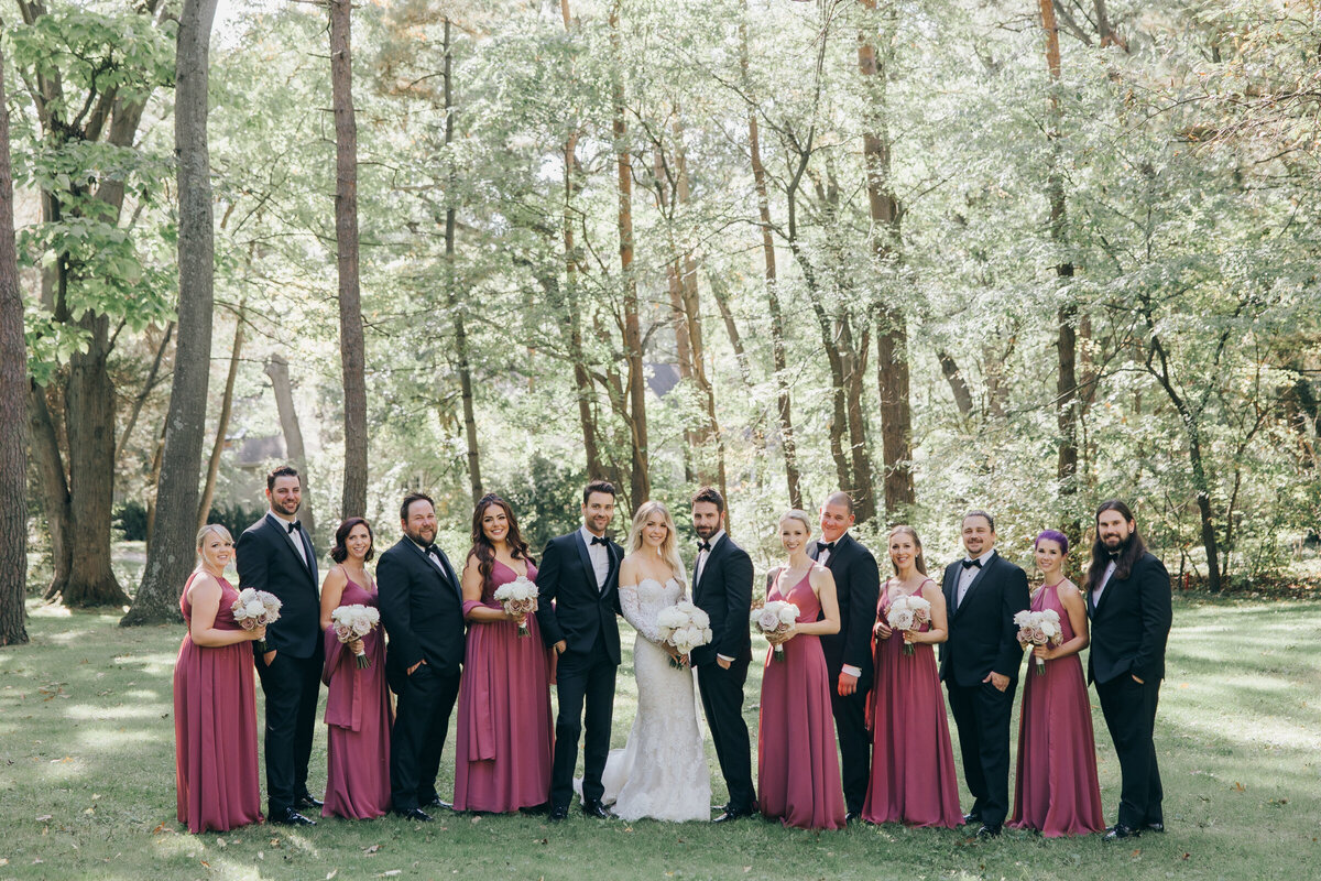 Wedding party portraits of bridesmaids in pink and groomsmen in charcoal