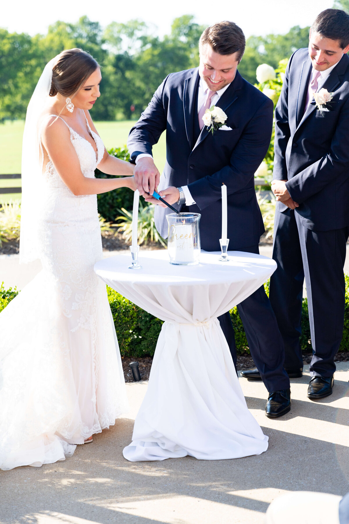 Bride and groom lighting a unity candle at wedding at Stones River Country Club