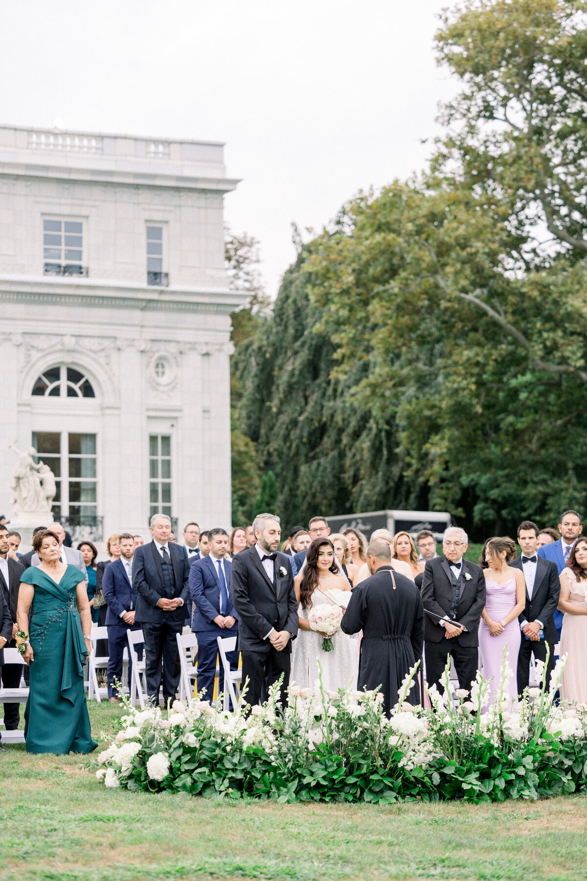 family and friends at wedding ceremony standing during bridal procession