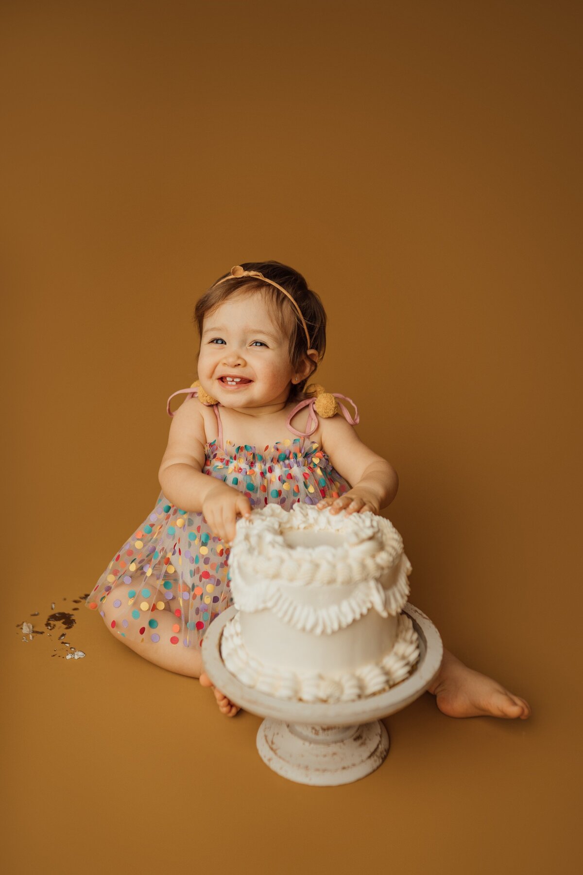 girl smiles while eating cake during photography session at studio in tampa