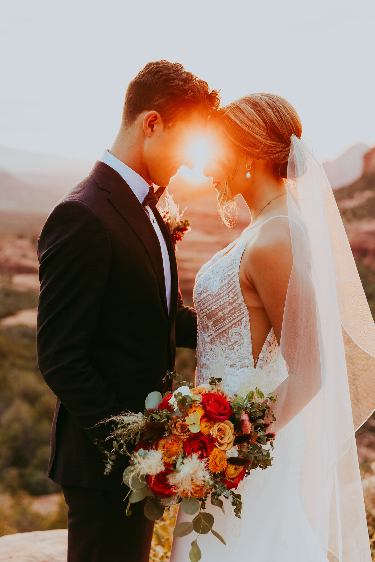 couple standing together with sunshine between them