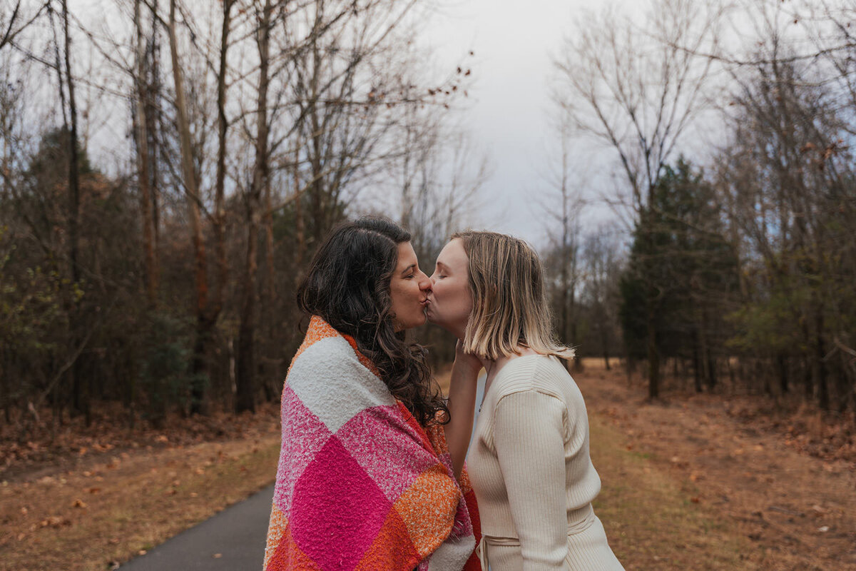 Women kiss in the path of a Nashville Tennessee park 