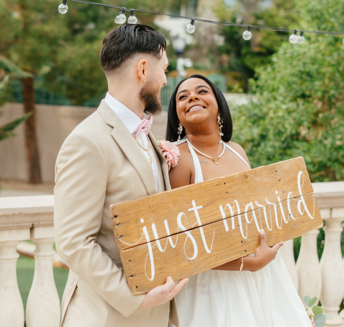 bride and groom holding just married sign at the stirling club in las vegas, nv