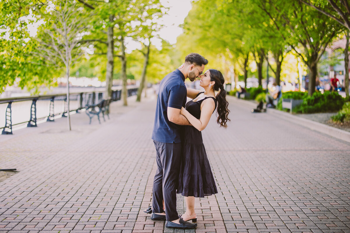A couple sharing a moment on the hoboken waterfront walkway in nj