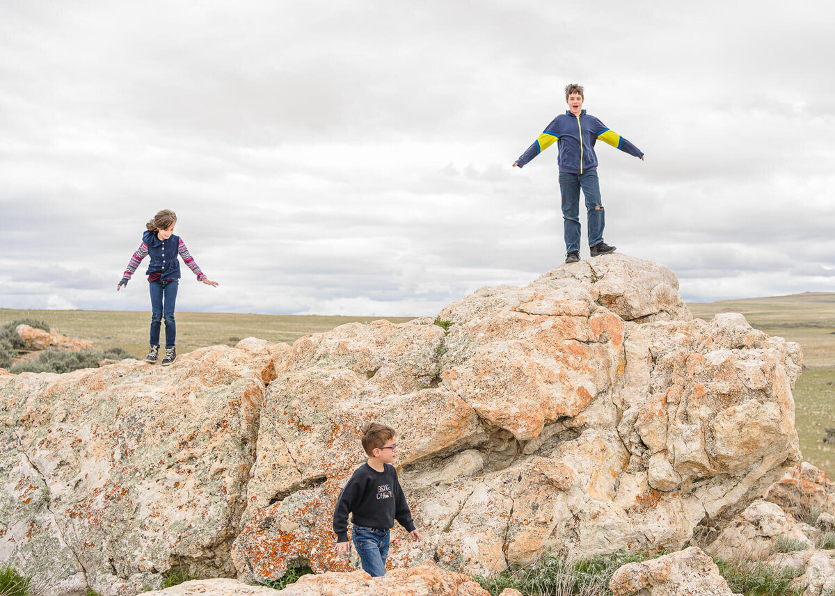 Three Woodruff kids climbing rocks at Antelope Island