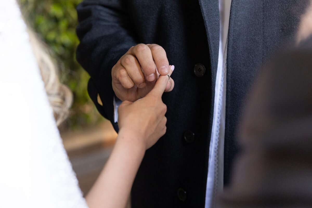 A person pulling a ring off of someone's finger