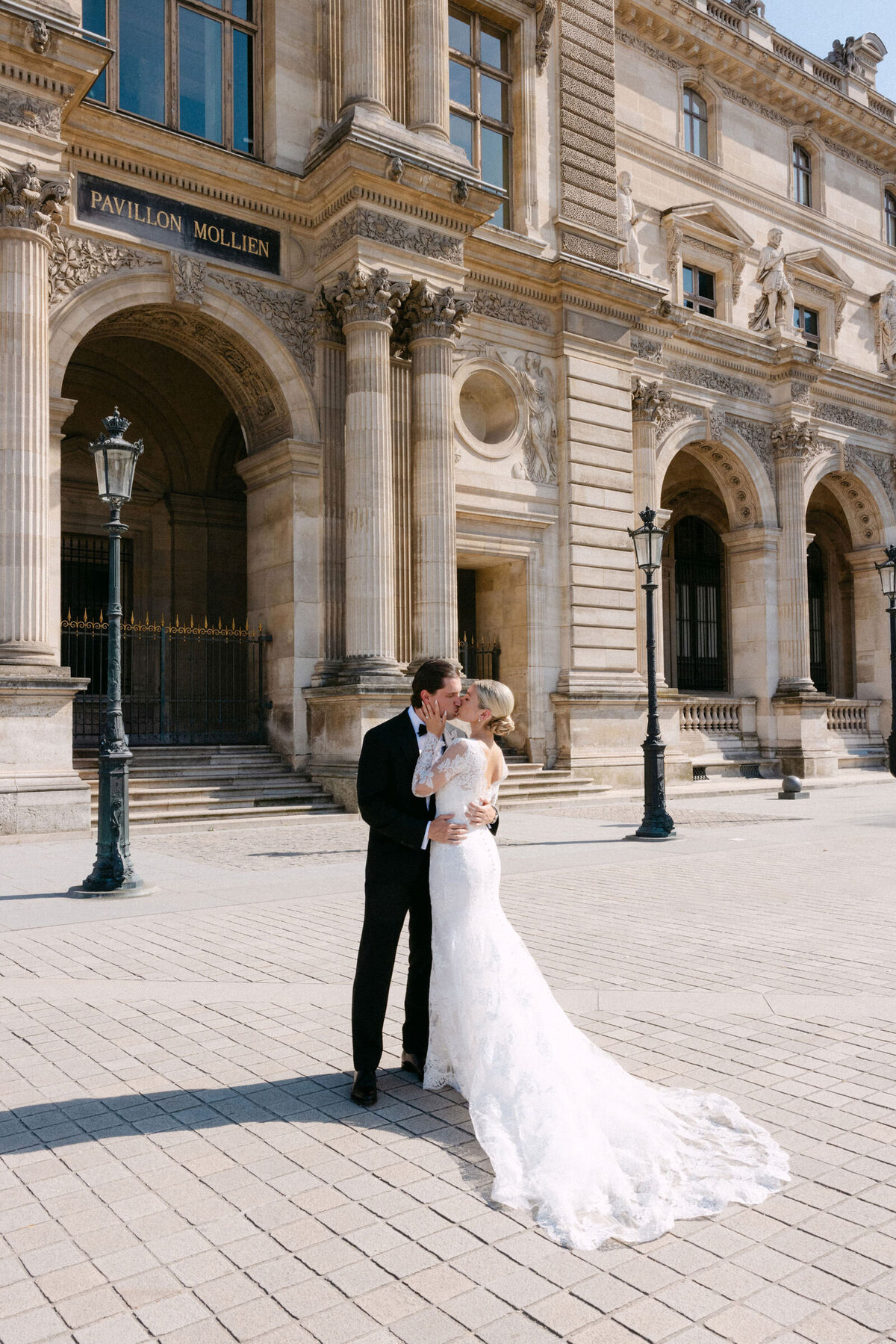 Couple hugging outside Ritz Paris hotel.