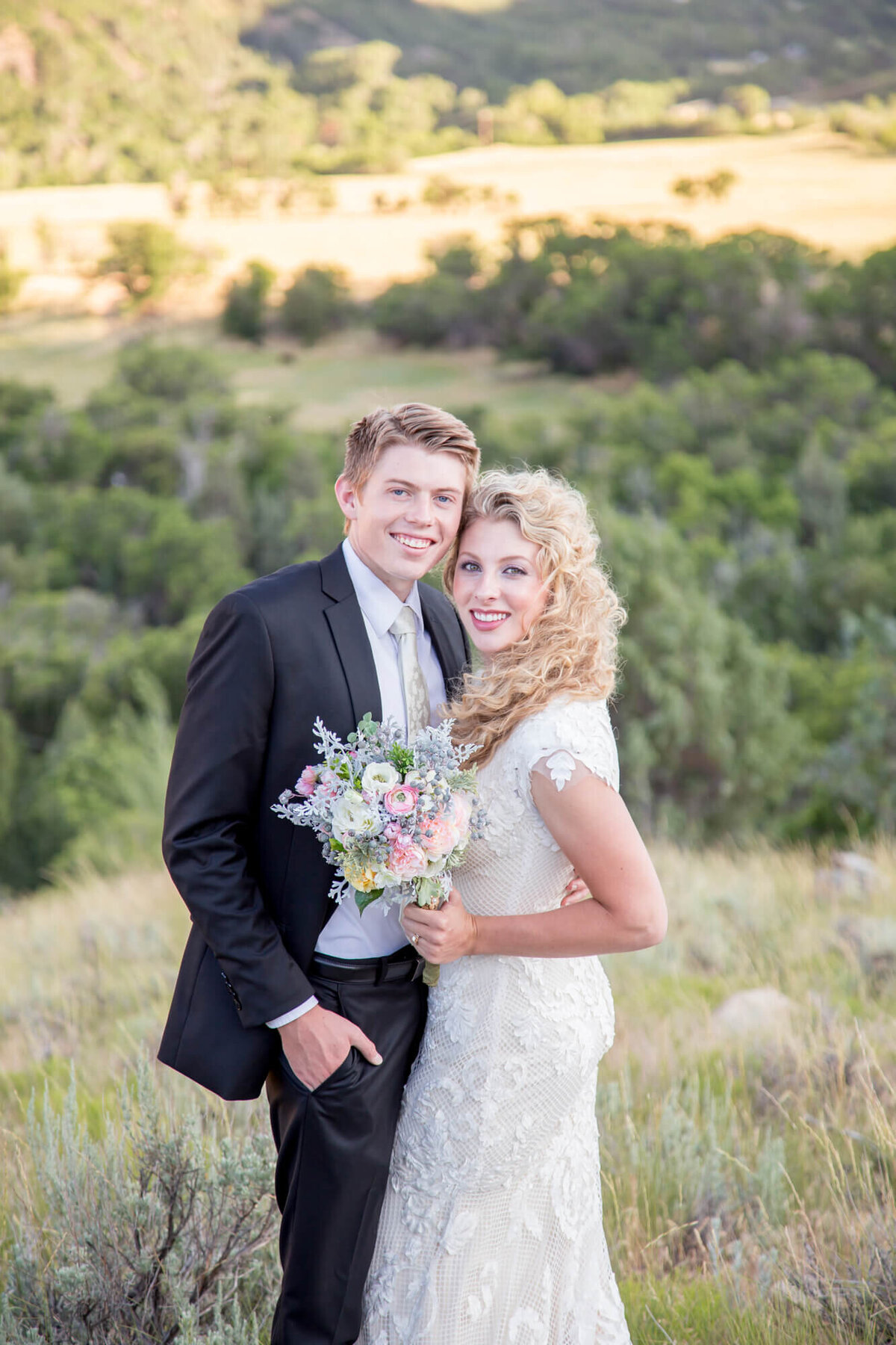 a bride holding a bouquet next to a groom