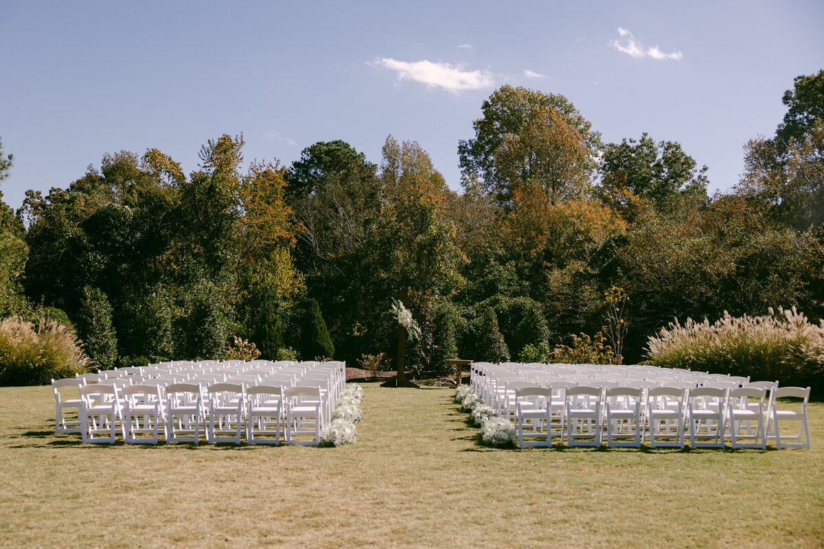 white lawn chairs outdoor ceremony