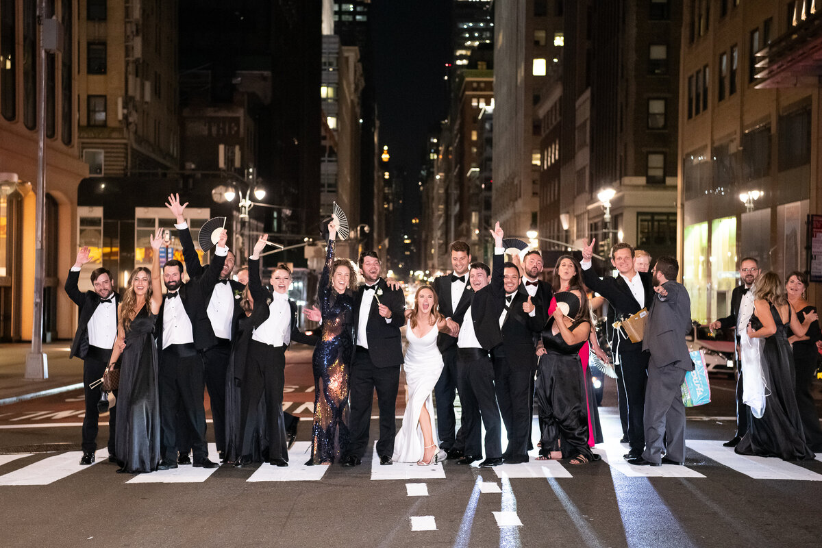 Wedding party walking through New York City Manhattan at nighttime