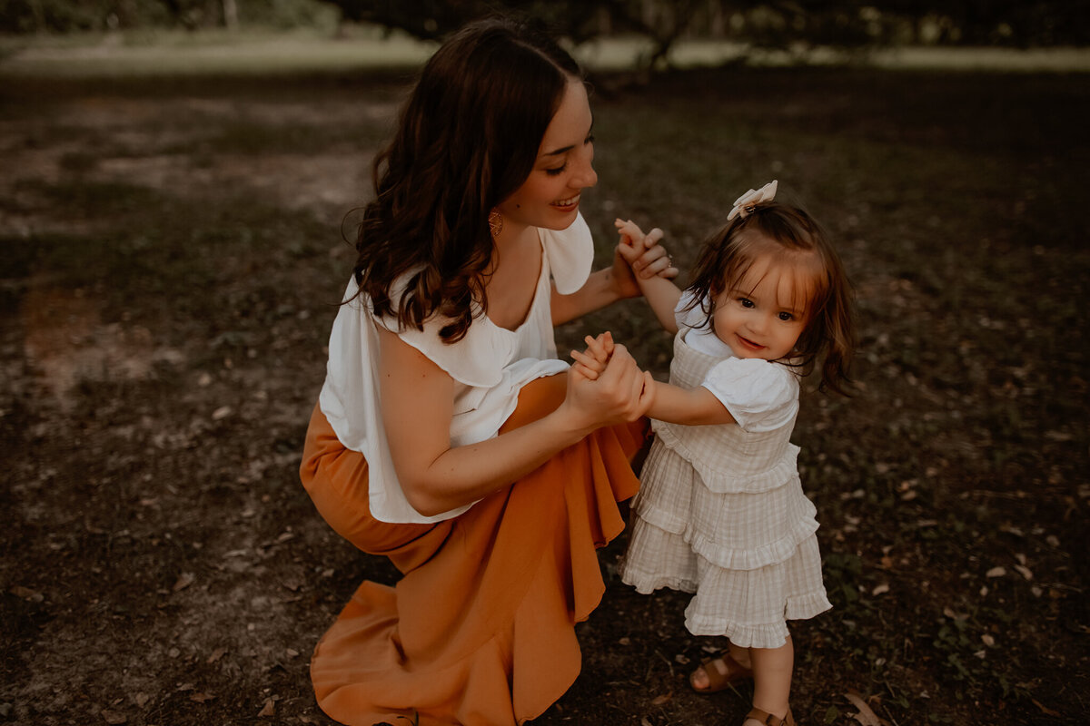 Spring, Tx mother and daughter smiling and dancing in the outdoors photos