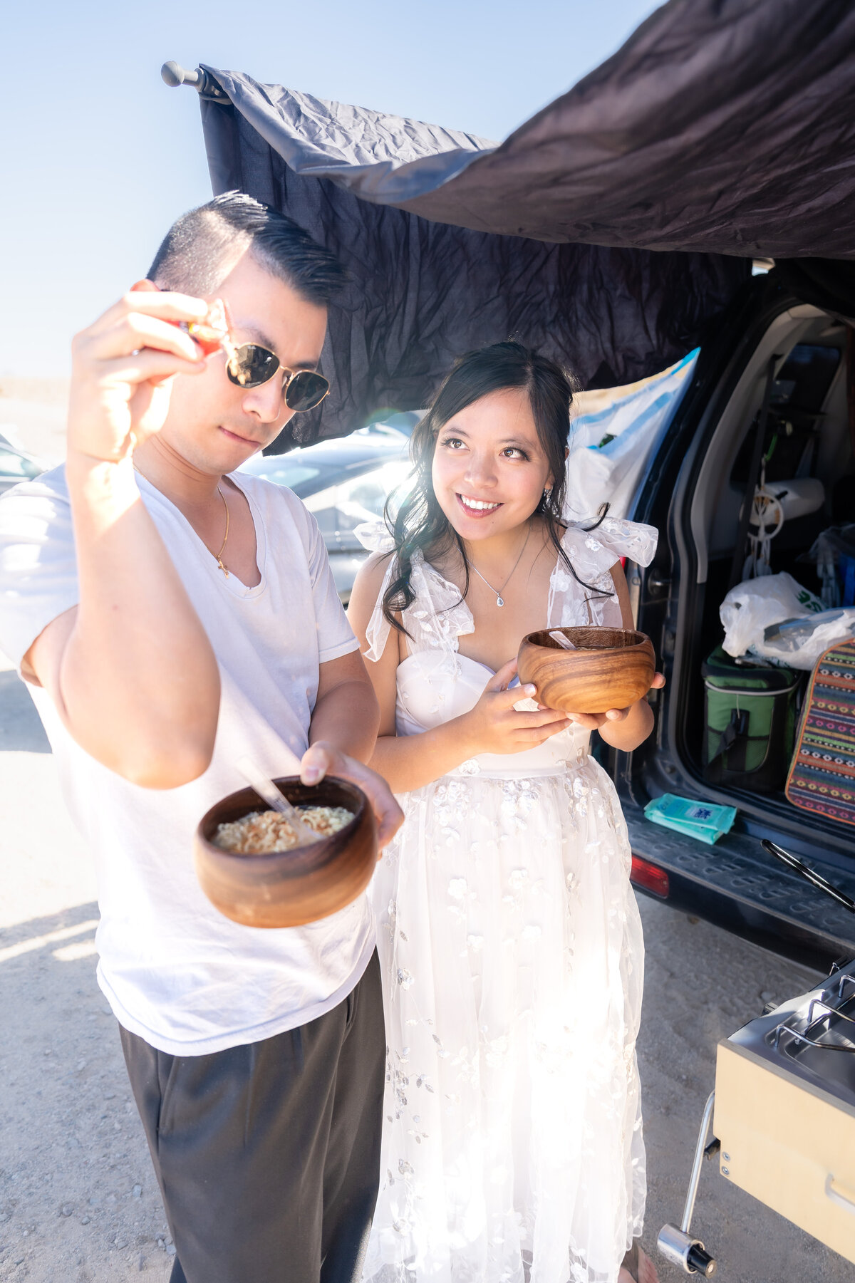 Anza Borrego elopement bride and groom eating ramen lunch and doing salt bae.