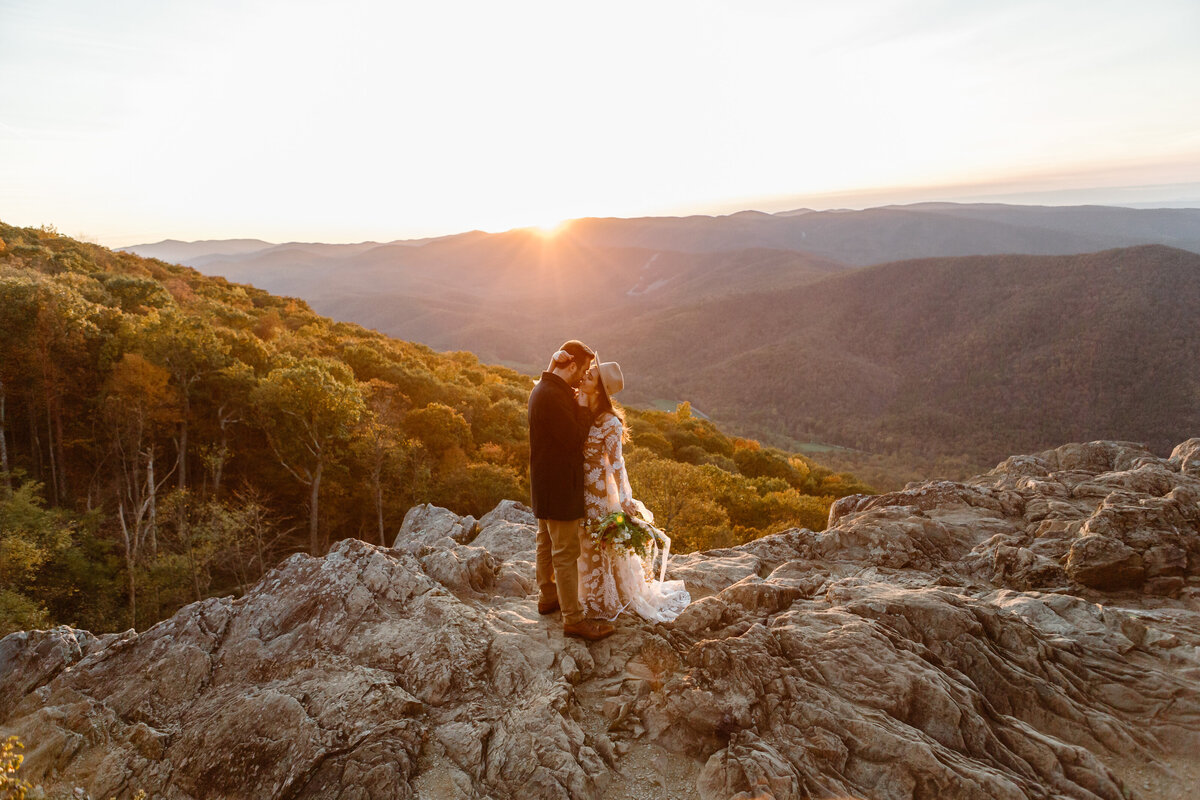 Bride and groom embrace on a mountain at Ravens Roost Overlook during their Virginia elopement.