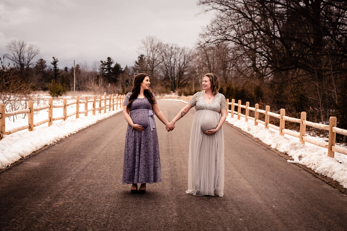 Pregnant best friends posing together for Toronto maternity photographer