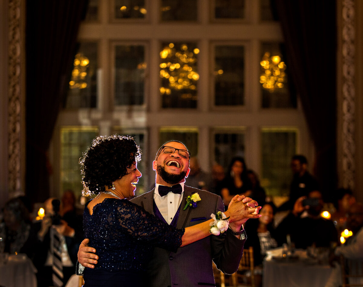 The groom laughs as he dances with his mother at Tudor Arms.