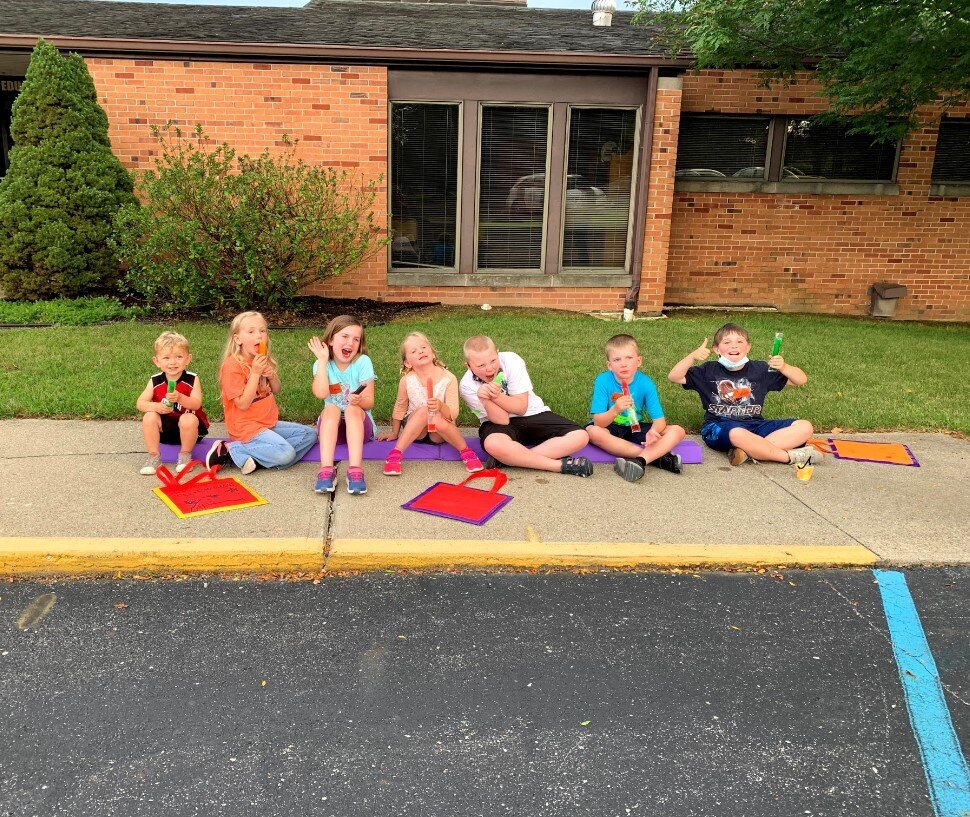 VBS kids hang out on the sidewalk at Bartlett Chapel
