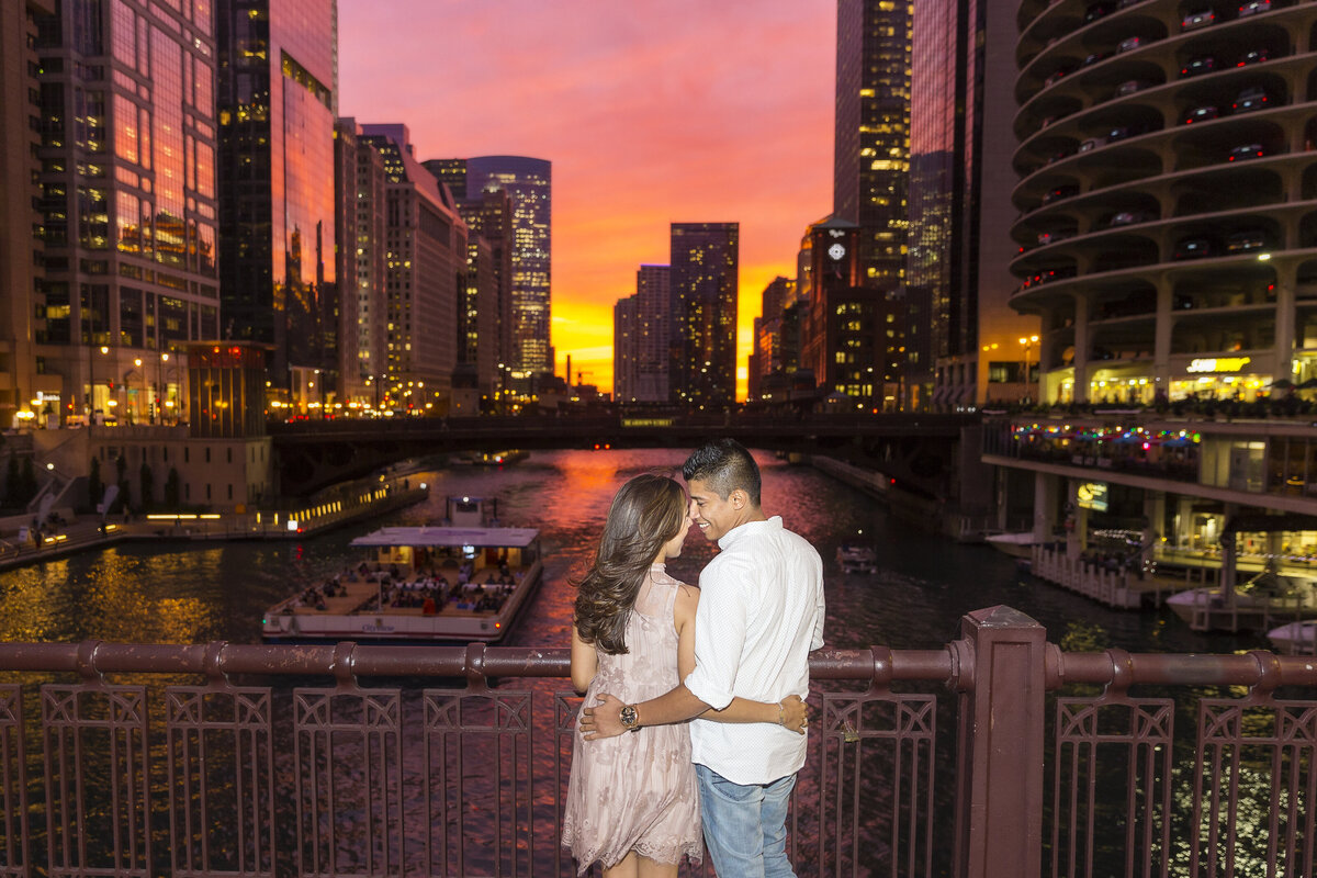 An engagement photo taken at sunset on the riverwalk in Chicago.