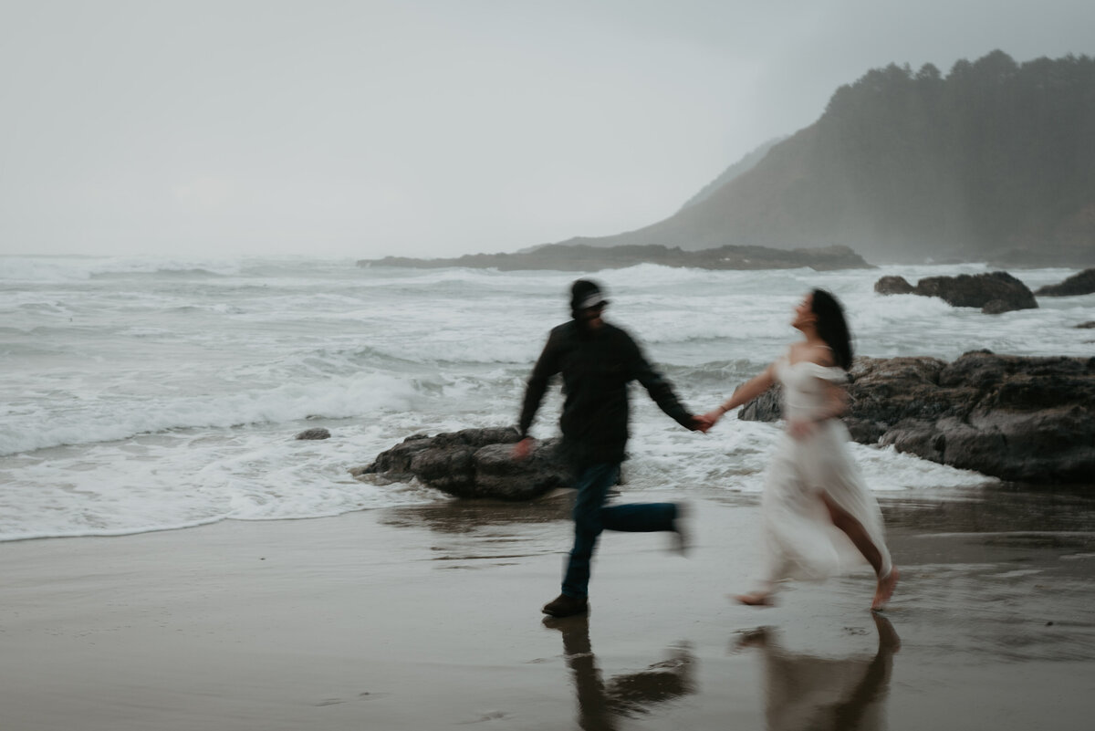 Blurry photo of couple running across the beach at the Oregon Coast