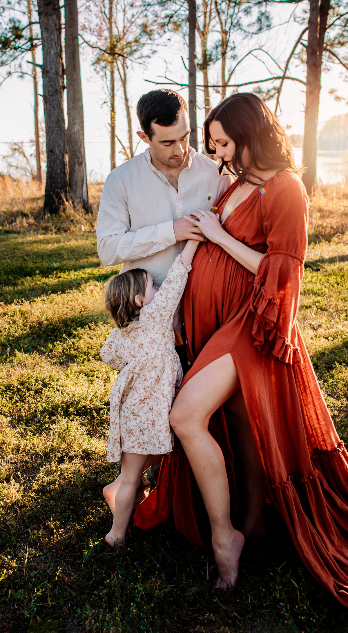 Daughter is giving expecting mom flower, they are in the field in Perrysburg